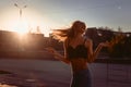 beautiful girl in lingerie and jeans dancing in the city at sunset Royalty Free Stock Photo