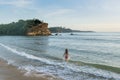 Sexy beautiful pretty woman in swimming suit walking on the beach during sunset time Royalty Free Stock Photo