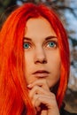 Sexy beautiful redhead girl with long, strong and thick hair. Perfect woman portrait on a background of autumn foliage. Gorgeous Royalty Free Stock Photo