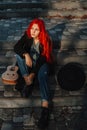 Sexy beautiful redhead girl with magnificent long hair. Ukulele playing, sitting on the steps in the park. Perfect woman portrait