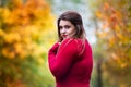 Sexy beautiful woman in autumn, cute plus size model in red sweater outdoors