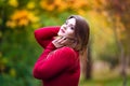 Sexy beautiful woman in autumn, cute plus size model in red sweater outdoors