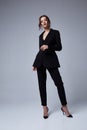 Sexy beautiful woman fashion glamour model brunette hair makeup wear black suit trousers jacket clothes office dress code casual Royalty Free Stock Photo