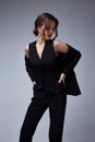 Sexy beautiful woman fashion glamour model brunette hair makeup wear black suit trousers jacket clothes office dress code casual Royalty Free Stock Photo