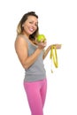 beautiful woman holding green apple fruit and measure tape in healthy nutrition diet and fitness concept Royalty Free Stock Photo