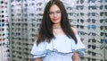 sexy beautiful woman staring at camera. Portrait of smiling female customer wearing spectacles in optical store, in an Royalty Free Stock Photo