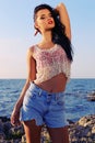 beautiful woman wears a top with jeans shorts and posing beach Royalty Free Stock Photo