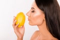 Sexy beautiful young standing in profil woman sniffing the scent of lemon