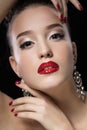 Beauty Girl with Red Lips and Nails. Luxury Woman, jewelery earrings.