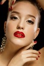 Sexy Beauty Girl with Red Lips and Nails. Luxury Woman, jewelery earrings.