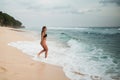 Sexy bikini body Latino woman with braids playful on paradise tropical beach Royalty Free Stock Photo