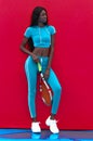 A black female model with a tennis racket