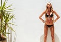 blond fashionable woman posing in a black bikini Royalty Free Stock Photo