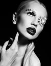 blond woman with fantastic makeup with bijou accessories