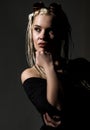 blonde beautiful woman with dreadlocks on a dark background in the studio Royalty Free Stock Photo