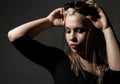 blonde beautiful woman with dreadlocks on a dark background in the studio Royalty Free Stock Photo