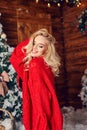 blonde girl in the red sweater, having fun and posing against the backdrop of Christmas decor. Winter and Christmas tree Royalty Free Stock Photo