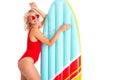 Sexy blonde girl in a red swimsuit and sunglasses with a swimming mattress Royalty Free Stock Photo