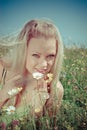 blonde on green meadow with camomile Royalty Free Stock Photo