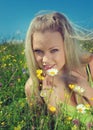 blonde on green meadow with camomile Royalty Free Stock Photo