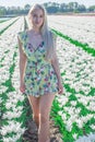 Sexy blonde at a photo shoot in a field of flowers and tulips Holland