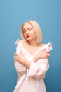 Sexy blonde in white men`s shirt is drawn on a blue background with closed eyes and red lipstick on the lips. Lady in oversized Royalty Free Stock Photo