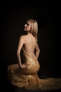 blonde woman in golden revealing evening dress Royalty Free Stock Photo