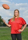 blonde woman playing American football Royalty Free Stock Photo