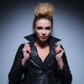 blonde woman pulling her leather jacket's collar Royalty Free Stock Photo