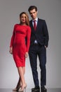 blonde woman in red dress standing next to businessman Royalty Free Stock Photo