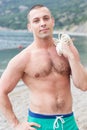 body builder is posing on the beach Royalty Free Stock Photo