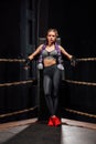 boxing girl stands leaned on ropes of competition ring. Royalty Free Stock Photo