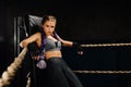 boxing girl stands leaned on ropes of competition ring. Royalty Free Stock Photo