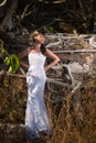 Bride posing in the middle of tropical trees in the mountains