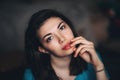 Sexy brunette dark eyes young women girl sitting at home touching lips looking camera sensual close-up Royalty Free Stock Photo