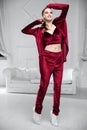 Sexy brunette dressed in a burgundy velor suit