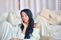 Sexy  brunette girl sits on sofa  in sweaters and socks Royalty Free Stock Photo