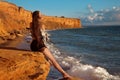 Sexy brunette summer girl with long healthy hair enjpying on the beach at sunset. Freedom summertime vacation concept. Enjoyment Royalty Free Stock Photo