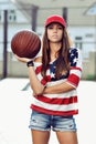 brunette woman holding basketball in hand