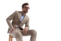 Sexy businessman sitting on a chair, wearing eyeglasses Royalty Free Stock Photo