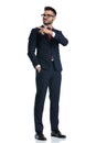 Businessman standing one way while looking and pointing the other Royalty Free Stock Photo