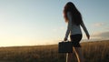 Sexy businesswoman girl running in the countryside. business woman walking along a country road with a briefcase in her Royalty Free Stock Photo
