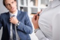 sexy businesswoman unbuttoning blouse near businessman Royalty Free Stock Photo