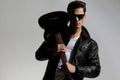 sexy casual guitarist in black leather jacket holding guitar and posing Royalty Free Stock Photo