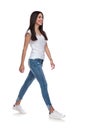 casual woman wearing a white t-shirt walking to side Royalty Free Stock Photo