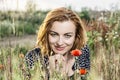 caucasian brunette and corn poppy flowers, beauty and natur Royalty Free Stock Photo