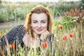 caucasian woman and corn poppy flowers, summer scene Royalty Free Stock Photo