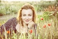 caucasian woman and corn poppy flowers, yellow filter Royalty Free Stock Photo