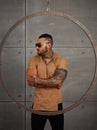 closeup portrait of Elegant handsome male model with fashion tattoo and a black beard standing and posing for model Royalty Free Stock Photo