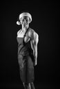 Sexy cook. Muscular man wear santa claus hat. Bodybuilder on black background. Winter holidays. Muscular sportsman